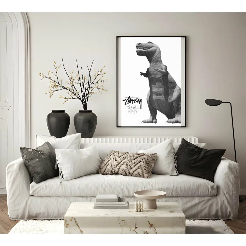 Living room with a white sofa, decorative pillows, and a framed black and white dinosaur print on the wall.