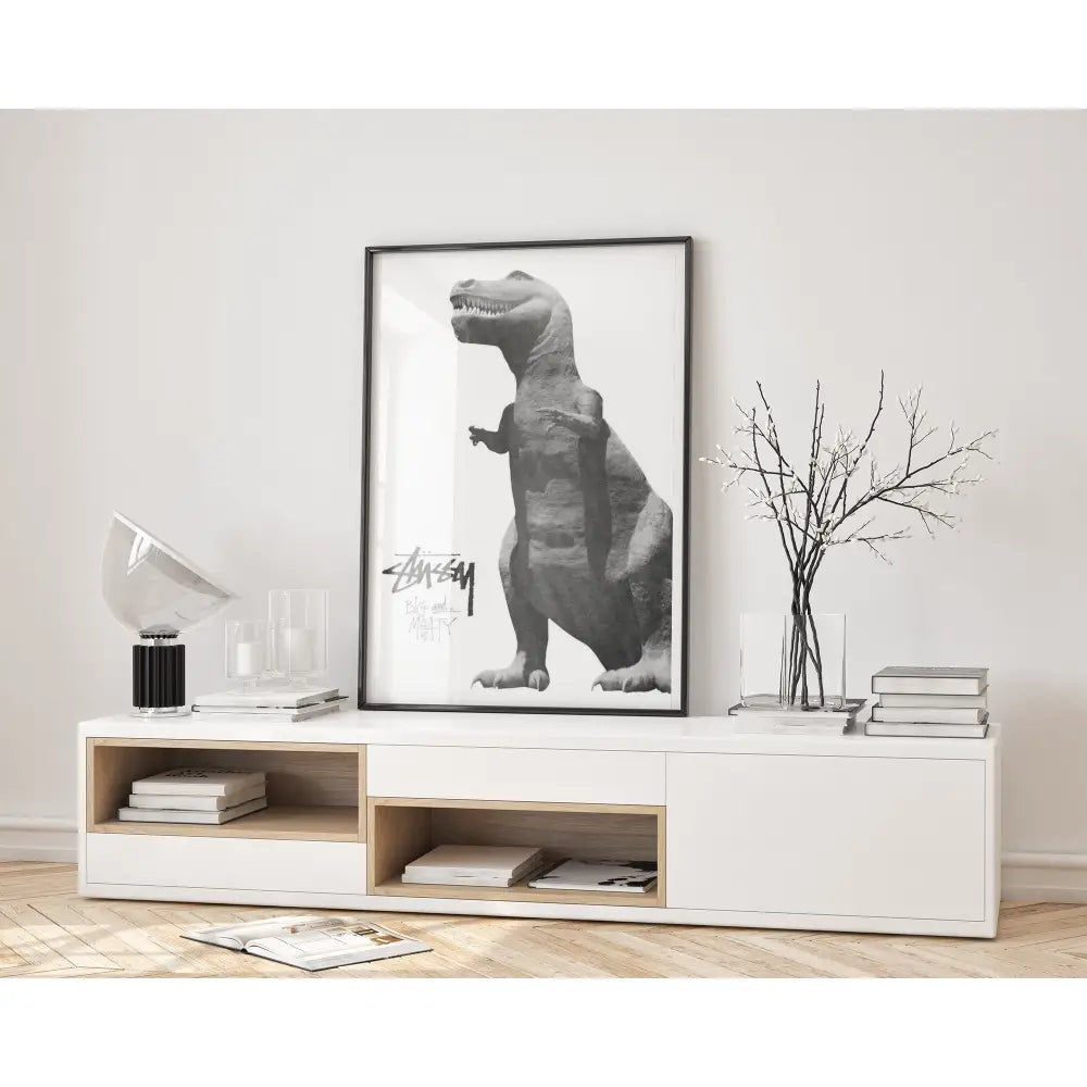 Modern interior with a white console table, books, and a framed black and white dinosaur print on a wall.