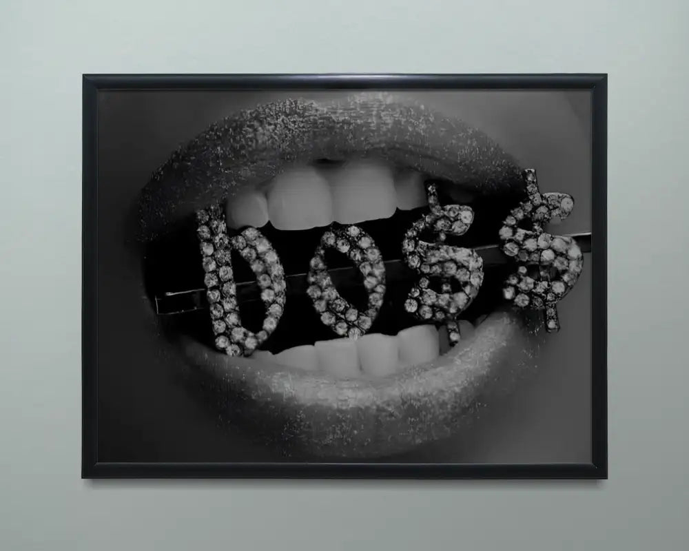 Framed artwork of a mouth with diamond-studded letters spelling 'DOS' on a gray background