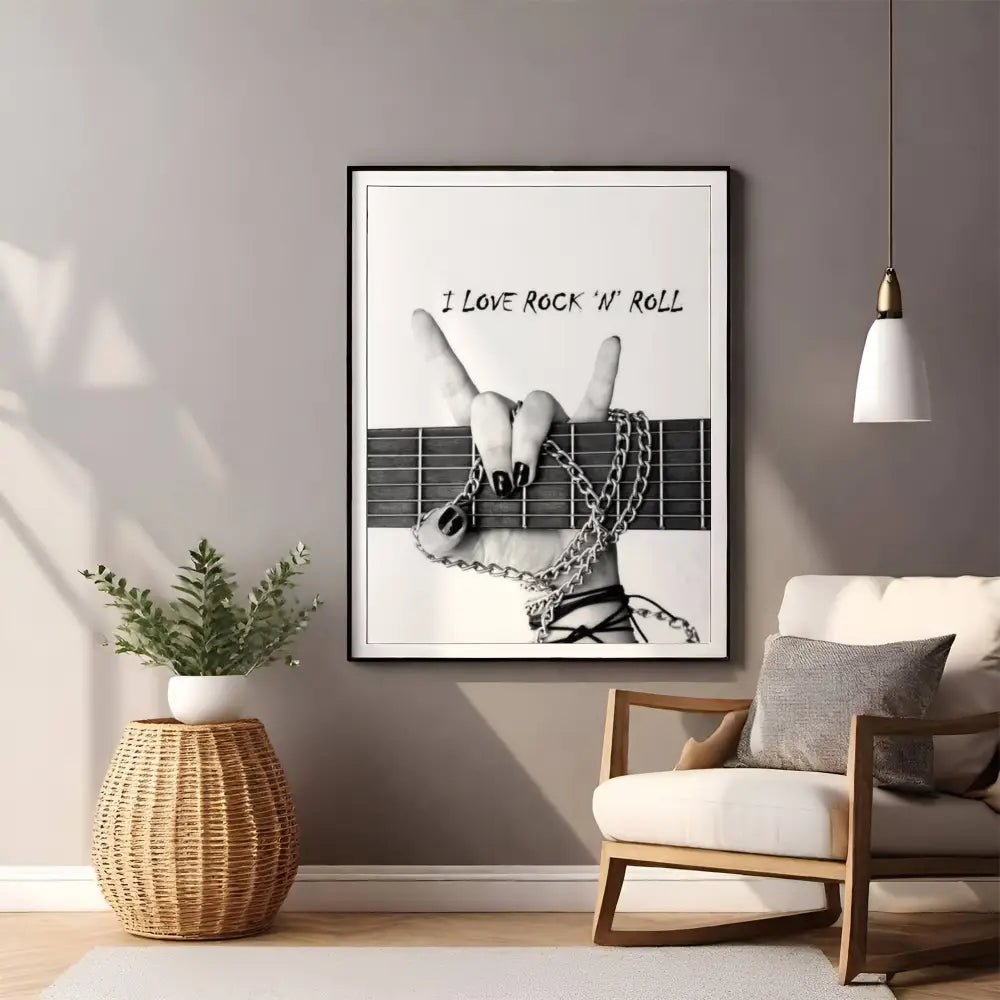 Living room with a framed poster of a hand on a guitar neck and 'I Love Rock 'n' Roll' text, a plant, and a chair.