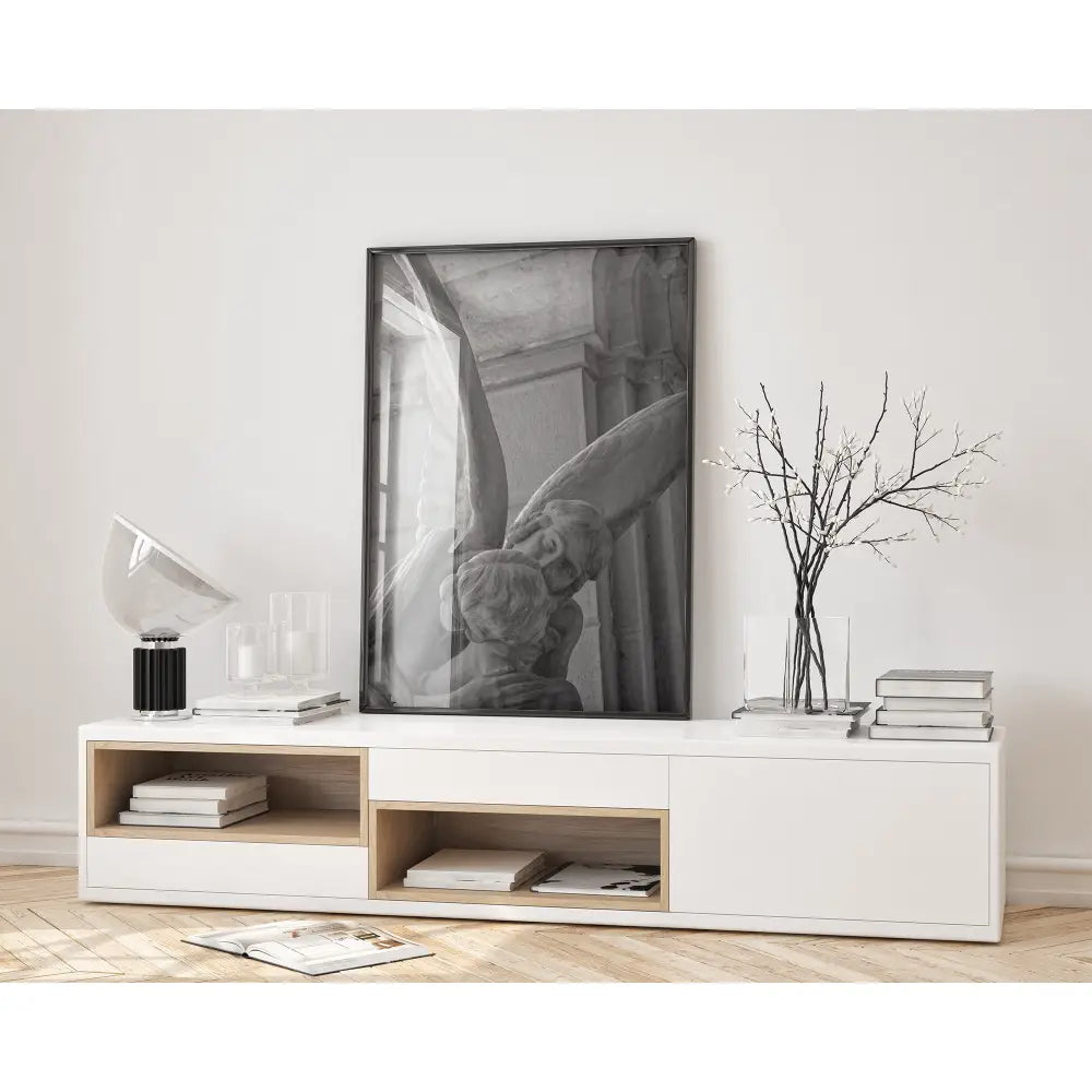 Modern living room with a white entertainment console, framed artwork, and decorative items.