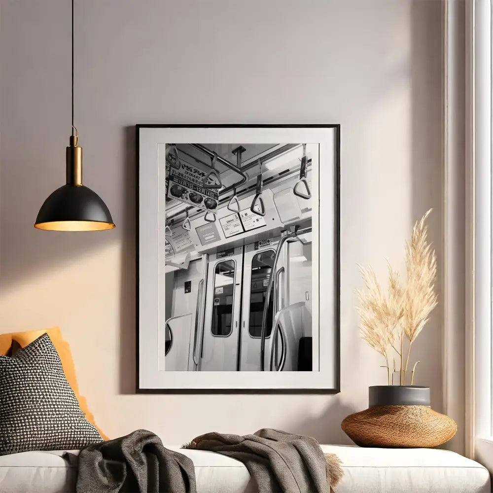 Framed black and white photo of a subway car on a wall above a sofa with decorative elements.