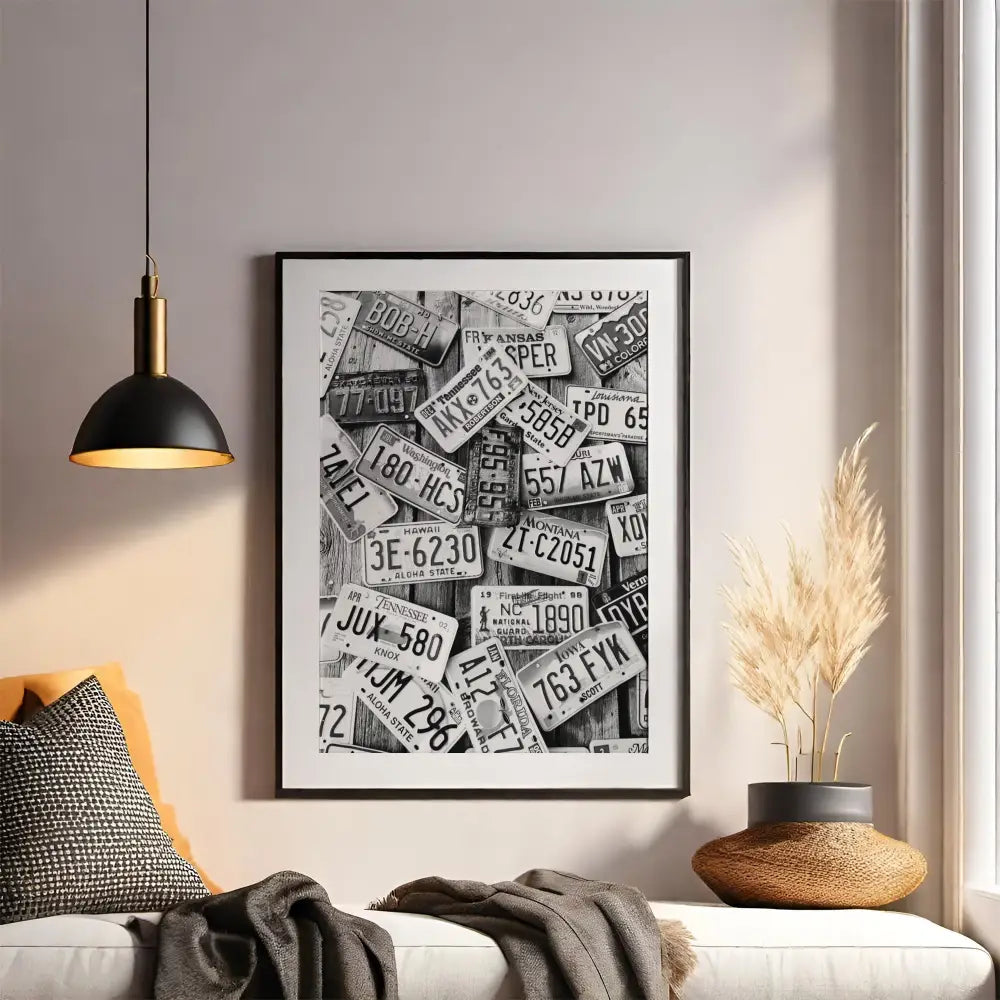 Framed artwork of license plates on a wall above a sofa with decorative elements.
